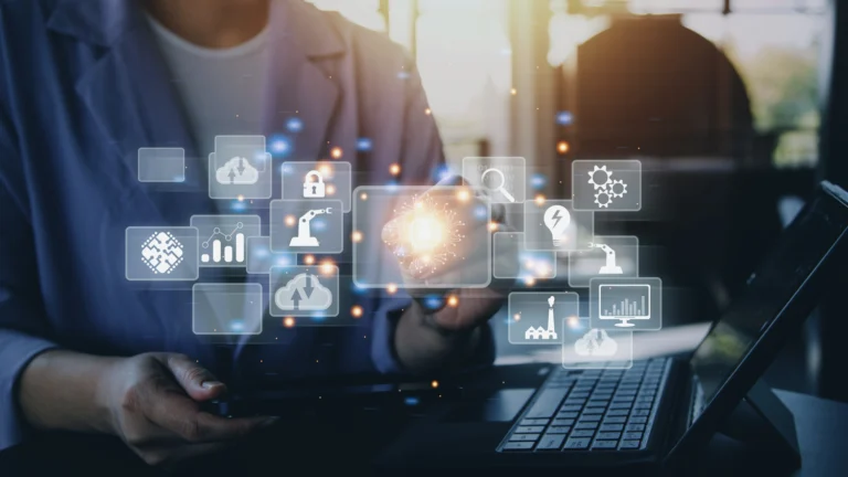 Person interacting with floating digital business and analytics icons over a laptop